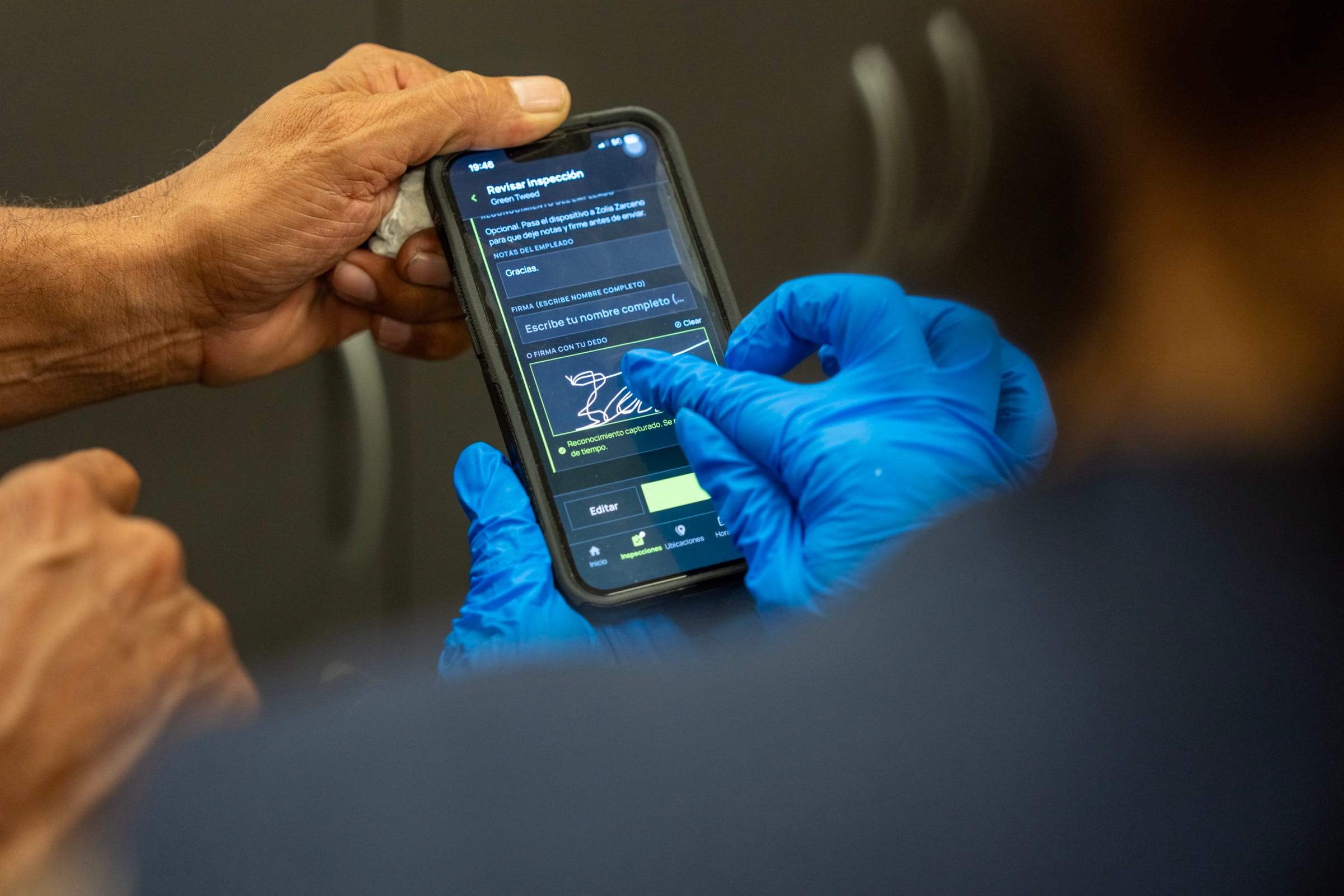 A gloved MGS crew member signing the employee acknowledgment on the inspection screen of the MGS Management App
