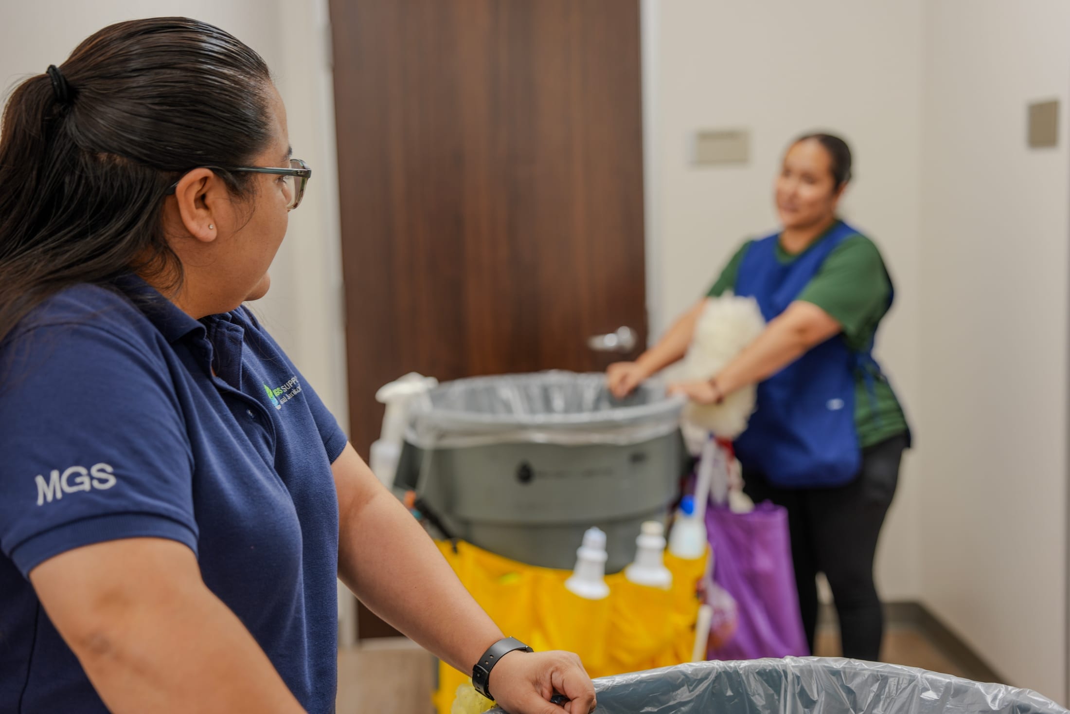 MGS crew members in uniform working together at a client facility